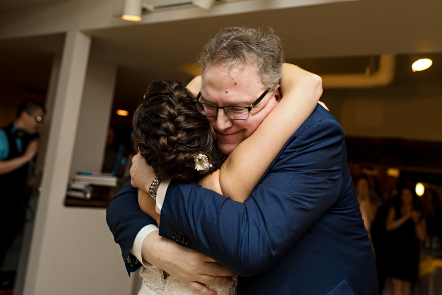 A father hugging his daughter at her wedding in Philadelphia.